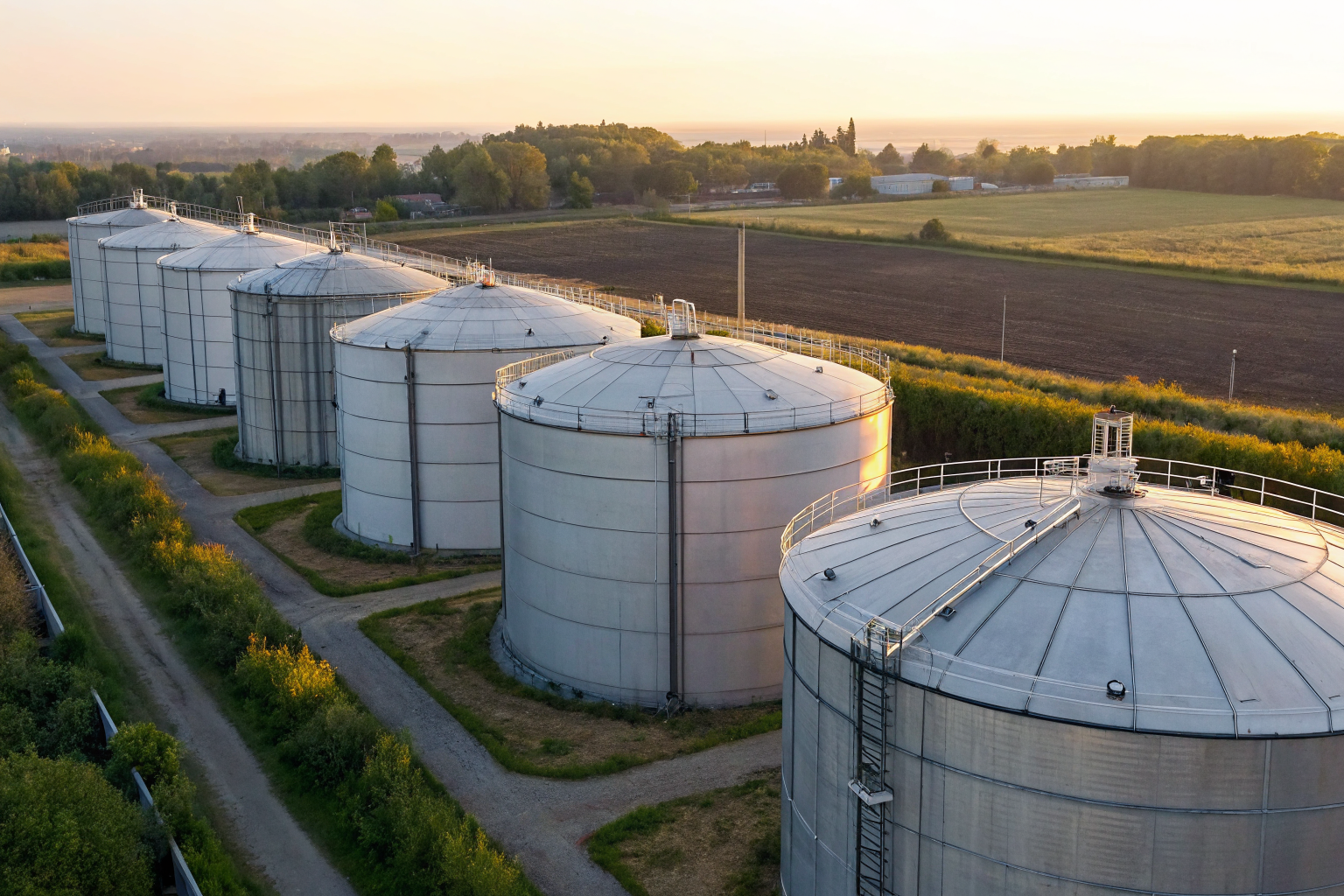 Farm with multiple storage tanks marked with capacities.