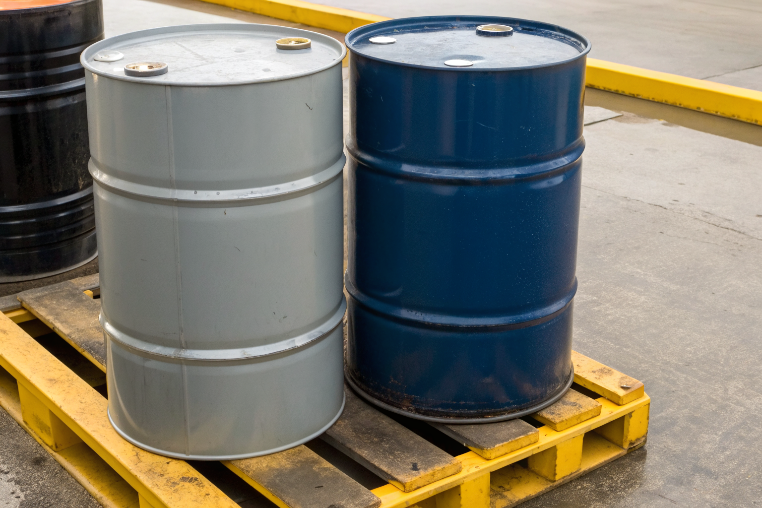 Polyethylene and steel spill pallet with two drums.