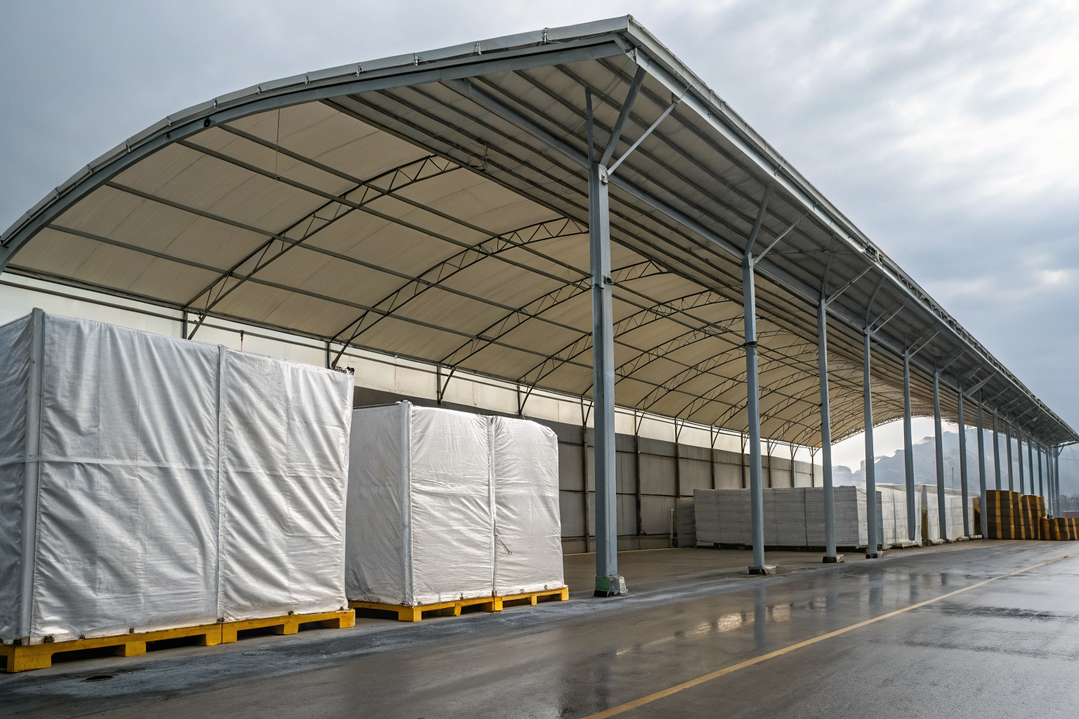Containment area with overhead protection using fabric covers and metal roofing.