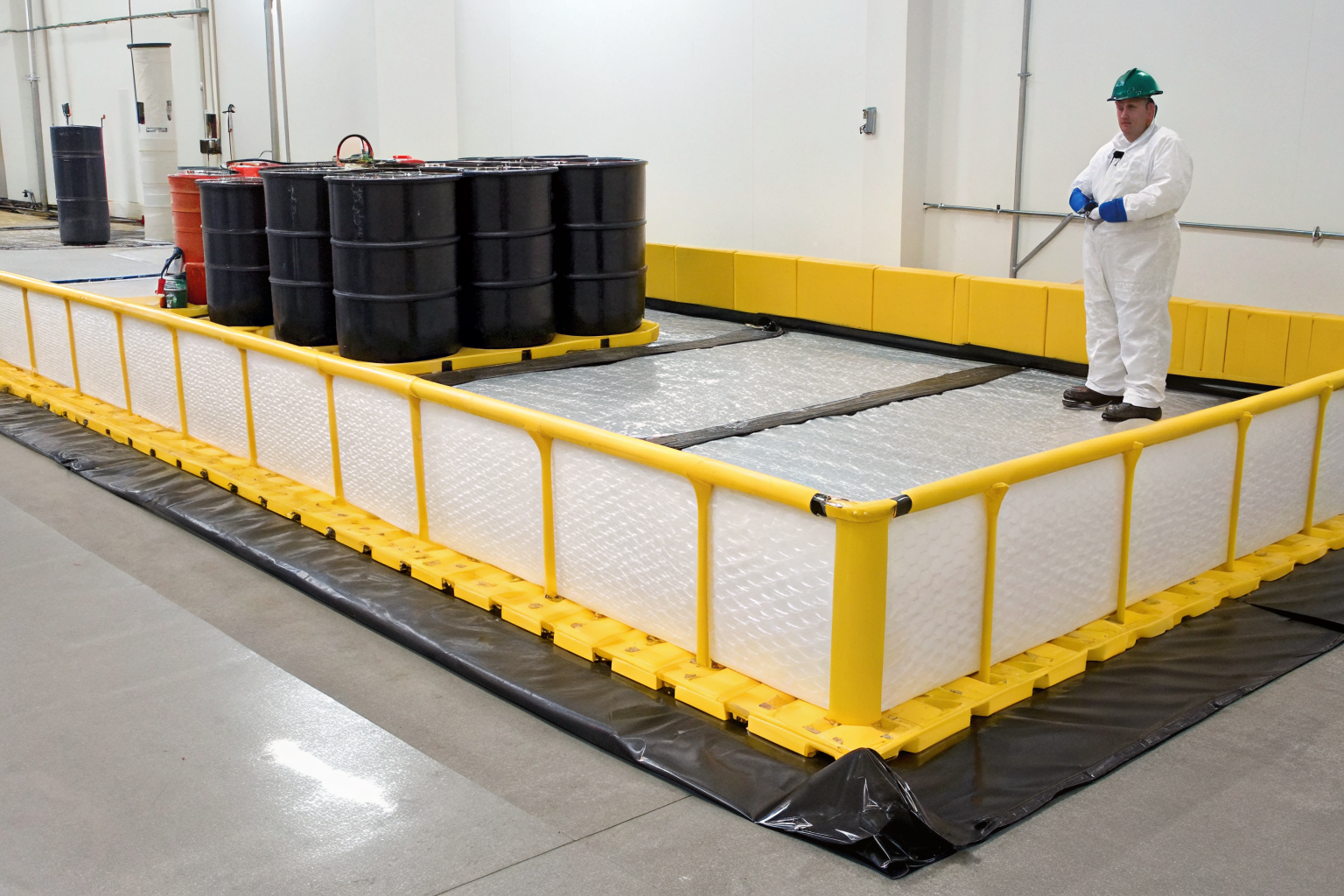 Physical barrier system capturing spilled oil during transfer operations.