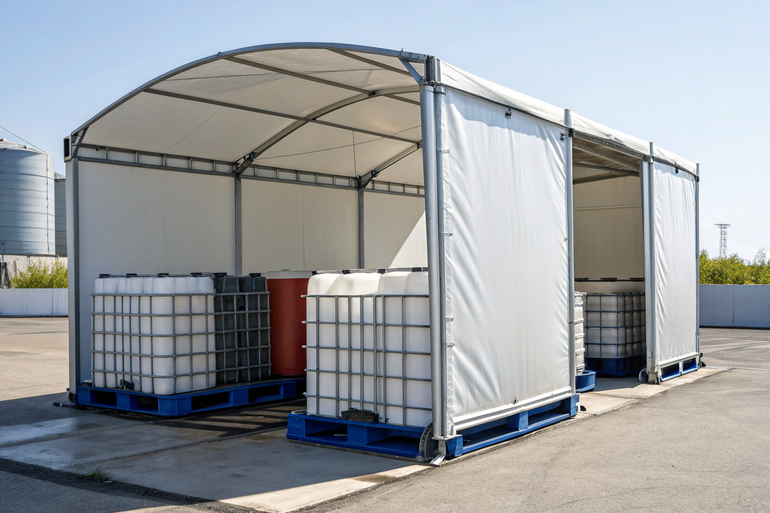 Rigid weatherproof shelter covering bulk containers outdoors.