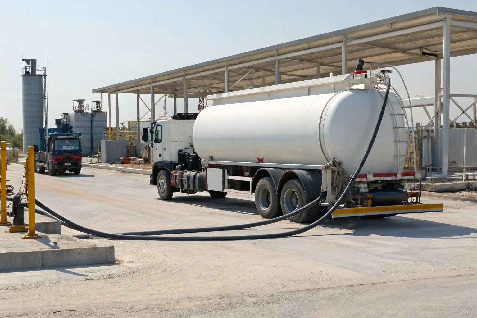 Vehicle-mounted mobile refueler parked with fuel storage system visible.