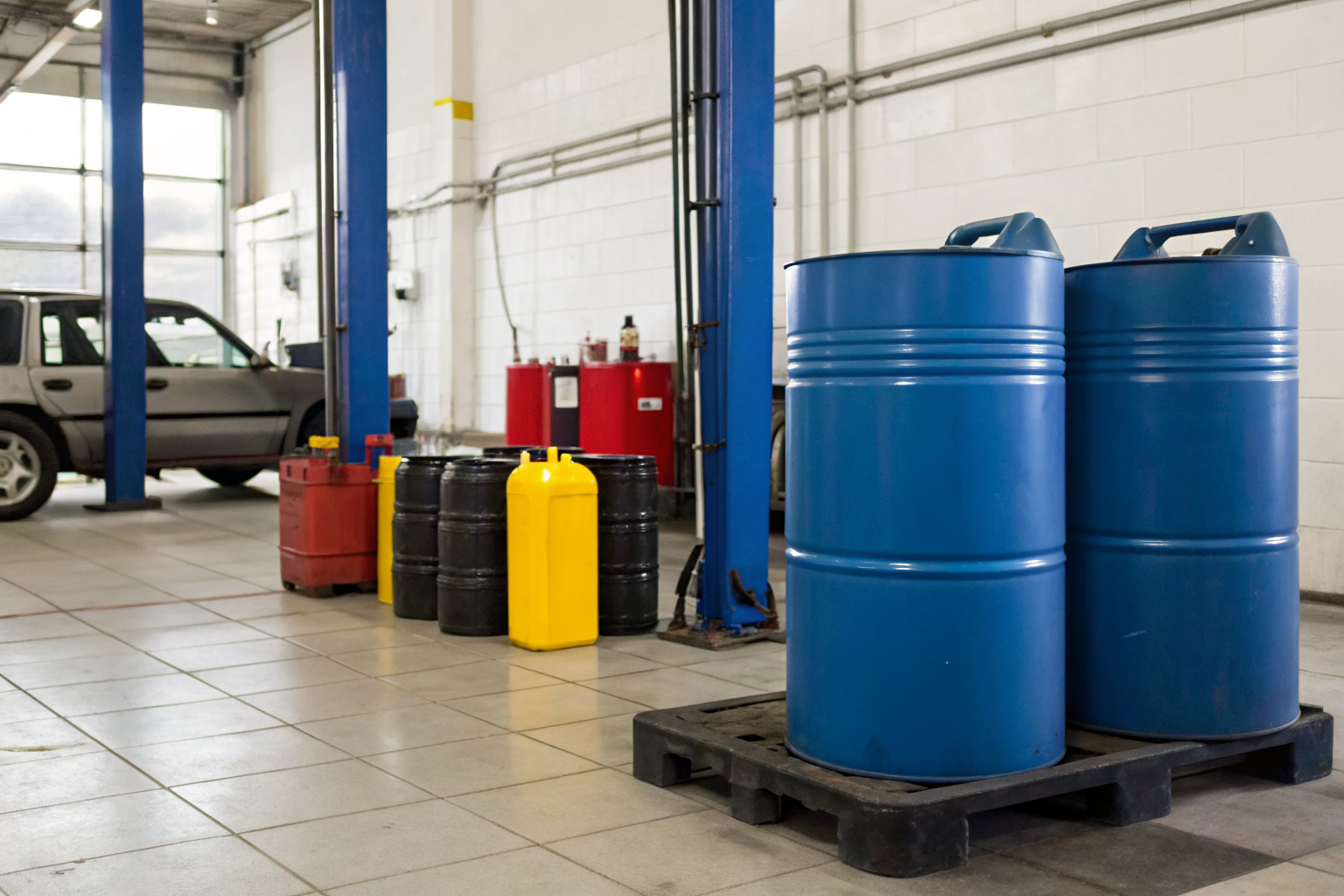 Service bay with labeled oil drums for SPCC compliance.