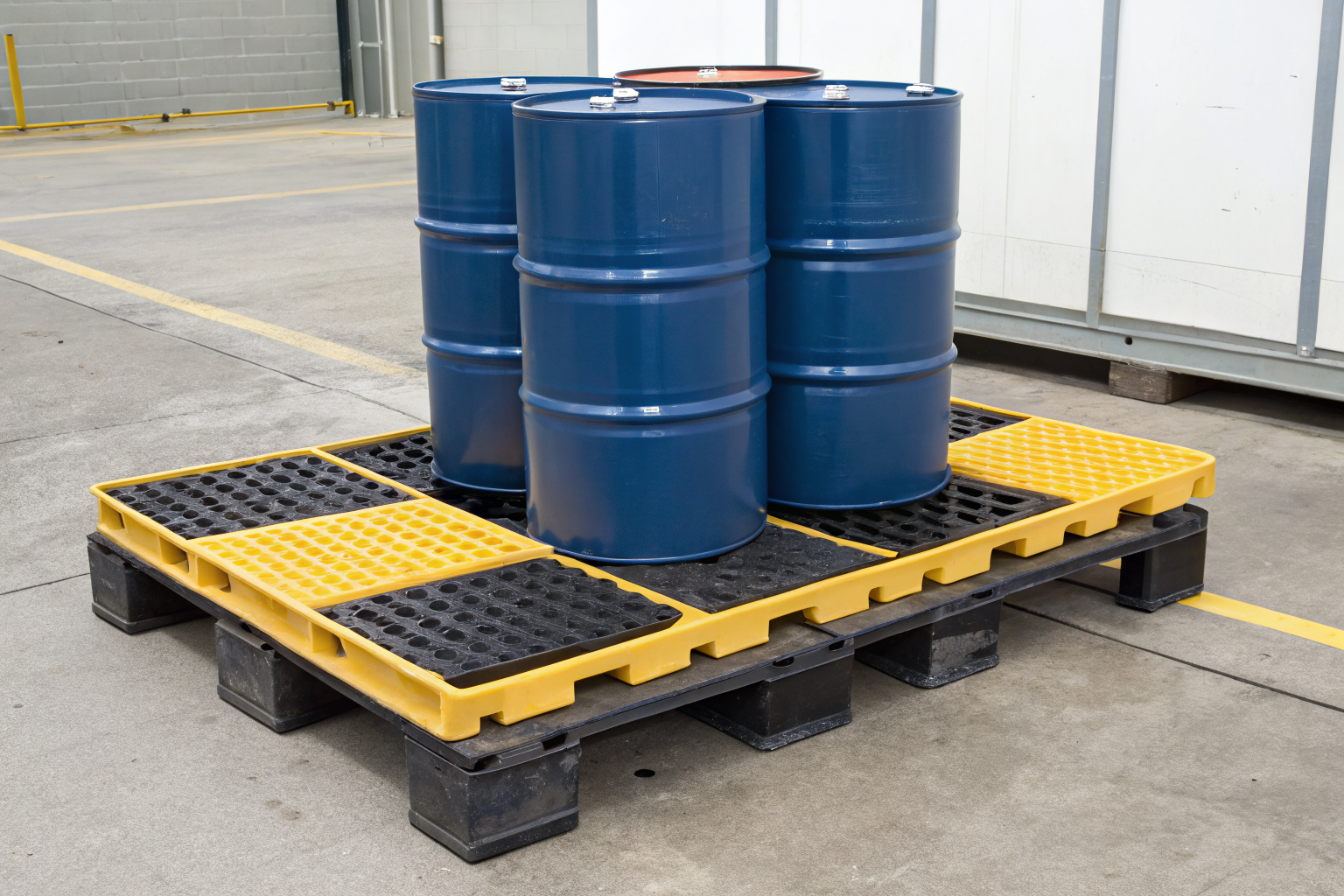Spill pallet with drum and equipment, showing raised design and capacity.