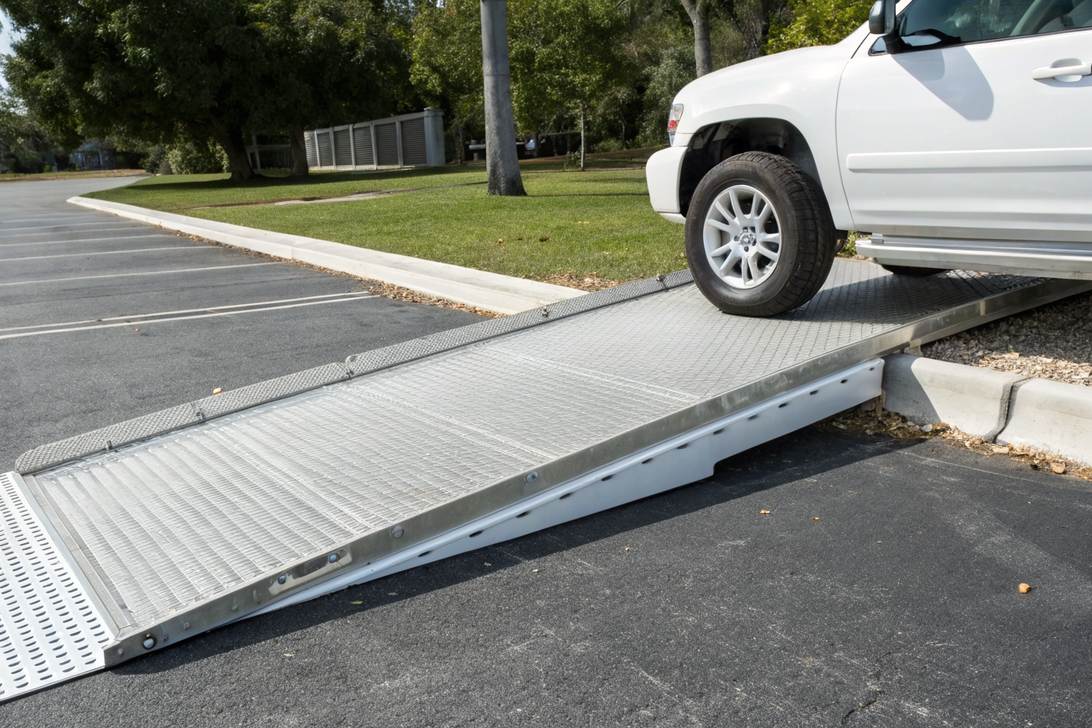 Low-profile ramp allowing vehicle access to spill berm.
